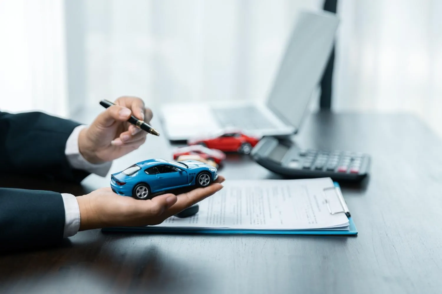 Person holding car keys after choosing a policy